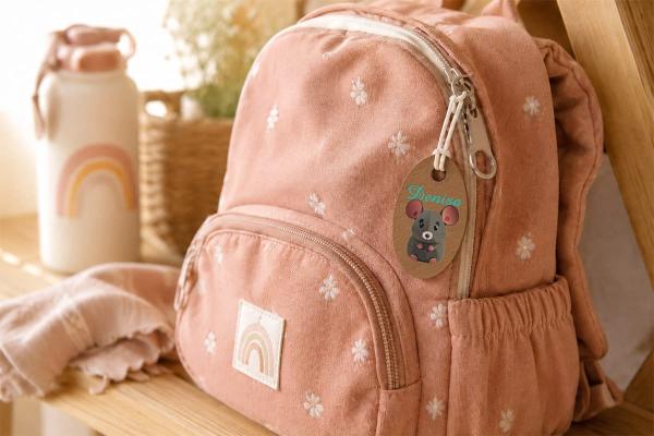 Étiquette ovale en similicuir de cactus durable, souris colorée et prénom « Denisa », sur sac rose.